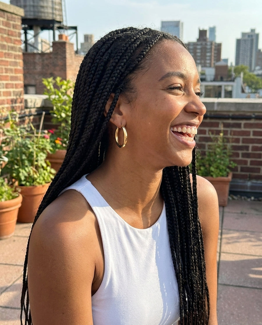 Charlotte Grand Hoop Earrings on a sunny rooftop