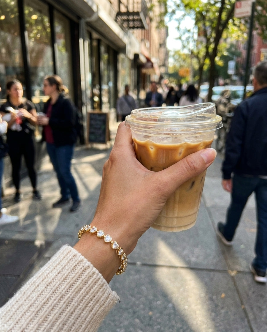Holly Heart Tennis Bracelet with an iced coffee